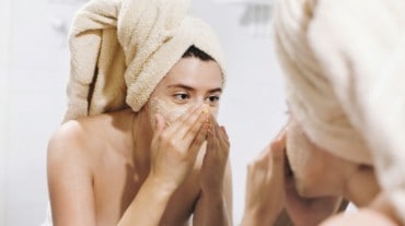 Woman using a face scrub